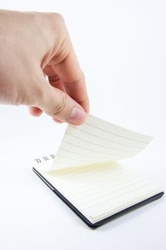 Hand picking notepad, notebook paper on white background