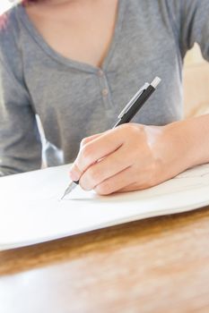 Woman hand using pencil drawing, sketching on paper