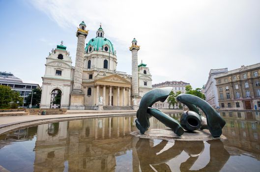 VIENNA, AUSTRIA - AUGUST 4, 2013: St. Charles's Church (Karlskirche) in Vienna with modern sculpture in front, Austria