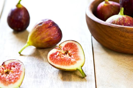 Fresh whole and halve Figs in wood bowl