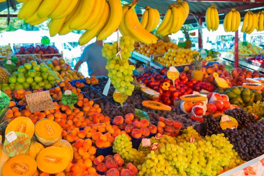 Market stall with variety of organic fruits.