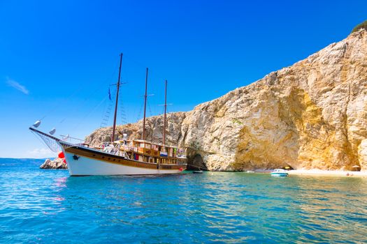 Vintage sailing boat anchored in an idyllic bay on Krk island in Croatia in Mediterranean sea.
