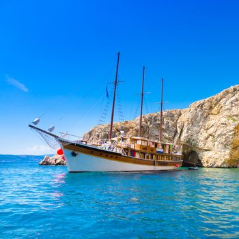 Vintage sailing boat anchored in an idyllic bay on Krk island in Croatia in Mediterranean sea.
