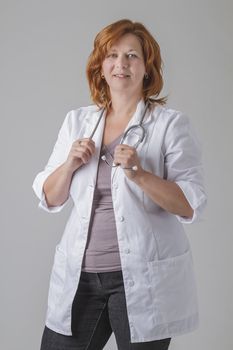 Forty year old woman doctor holding her stethoscope