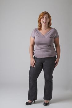 Round woman with red hair with laughing expression