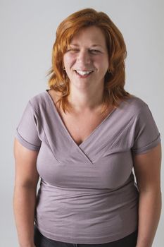 Red hair woman in her forties laughing