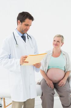 Cheerful pregnant woman having a check up with doctor at the hospital