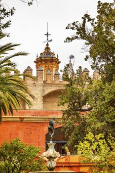 Church Steeples Statue Garden Alcazar Royal Palace Seville Andalusia Spain.  Originally a Moorish Fort, oldest Royal Palace still in use in Europe. Built in the 1100s and rebuilt in the 1300s. 