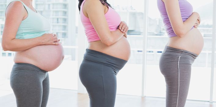 Pregnant women standing in a line in a fitness studio