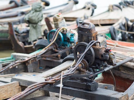 Primitive boat engines on traditional wooden boats at the harbour of Myeik in southern Myanmar.