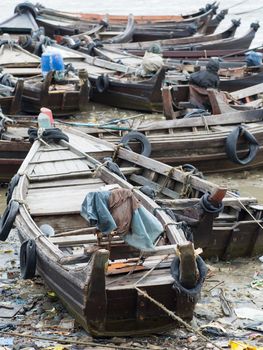 Traditional wooden boat along the polluted seaside at Myeik in southern Myanmar.