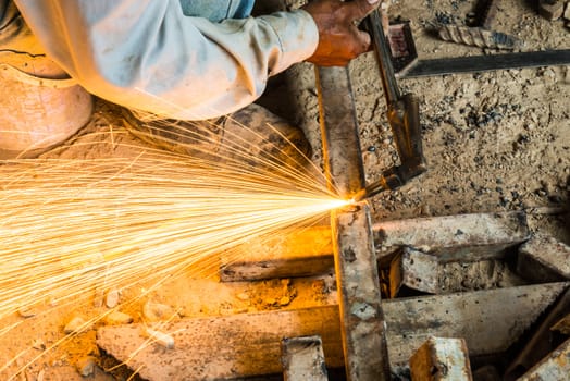 metal cutting with acetylene torch, focus on tools, low Light