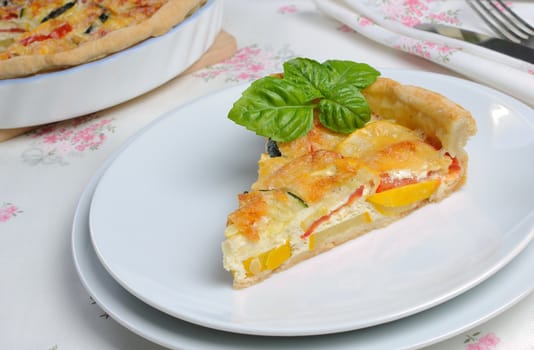 Quiche with zucchini (green, yellow) and tomatoes baked cheese