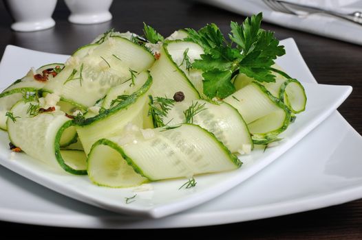 Acute appetizer of fresh cucumbers with garlic, dill, spices