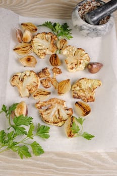 Warm appetizer of fried pieces of cauliflower with garlic and onion