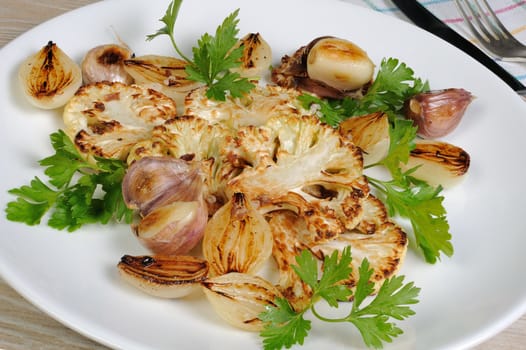 Warm appetizer of fried pieces of cauliflower with garlic and onion