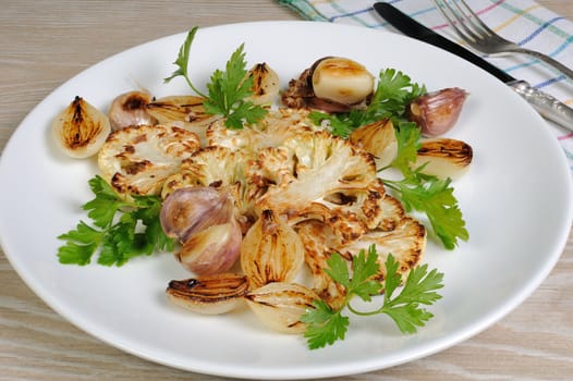 Warm appetizer of fried pieces of cauliflower with garlic and onion