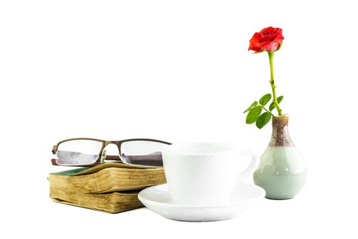still life white cup and pink zinnia book and glasses on a white background