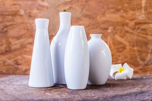 porcelain vases of various shapes on wood background