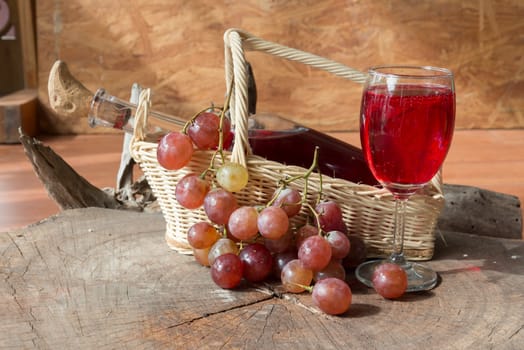 Wine and grapes on old wood.