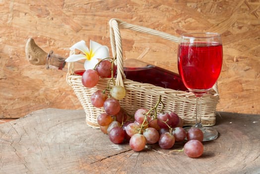 Wine and grapes on old wood.