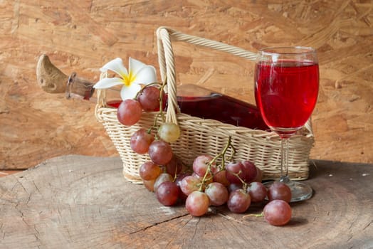 Wine and grapes on old wood.