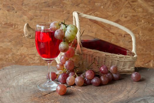 Wine and grapes on old wood.