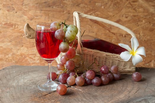 Wine and grapes on old wood.