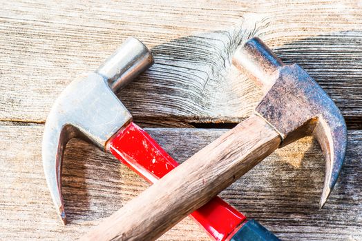 Hammer on a old wooden table top. Industrial tool.