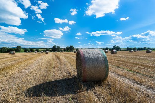 Hay bales on the field after harvest with great blue autumn sky