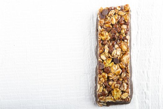 Chocolate Muesli Bar on white wooden background