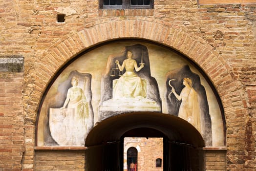 Fresco, justice that tramples the lie. Town hall of San Gimignano medieval town (UNESCO heritage), Siena, Tuscany, Italy