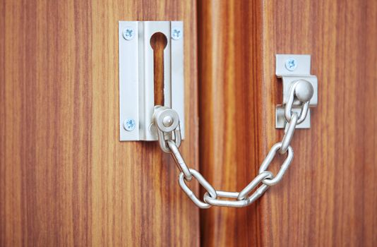 Metal padlock on the door. Close-up view
