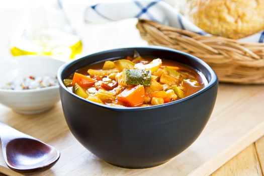 Vegetables soup with chickpea by bread loaf