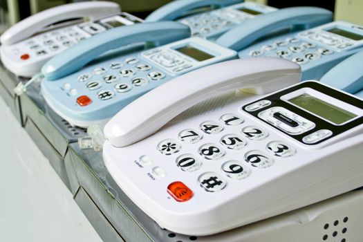 Set of telephones on a desk, receiver close-up