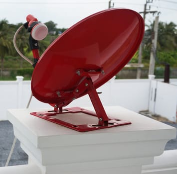 Red satellite dish, semi-circular shape. It was installed on the balcony.                                