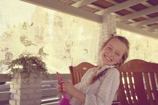 baby girl laughing heartily in a summer cafe