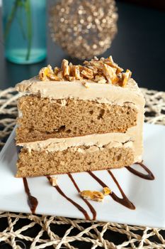 Slice of almond toffee cake with coffee flavored icing.
