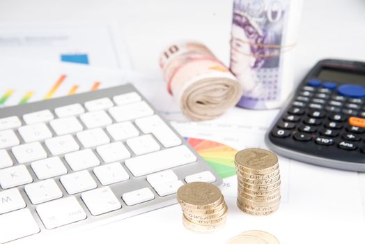 British pound sterling coins and bank notes on desk