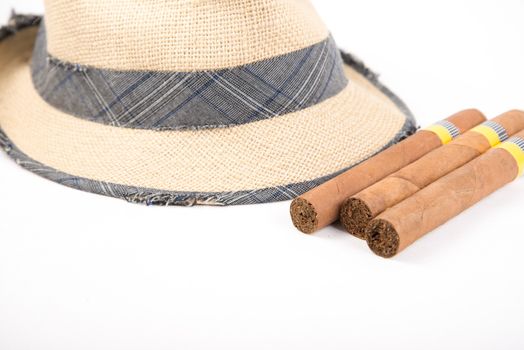 Cuban cigars and hat on white isolated background