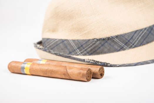 Cuban cigars and hat on white isolated background