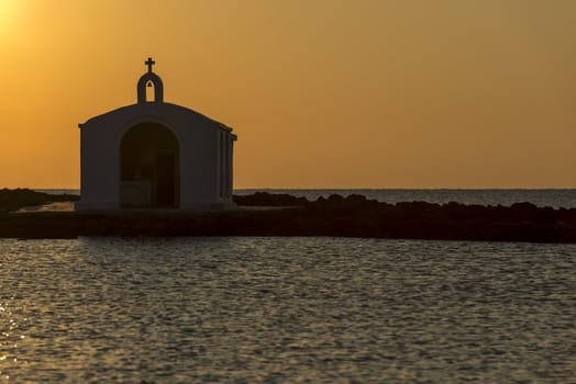 Catholic Church As Silhouette Against The Sunrise In Georgioupolis, Crete, Greece