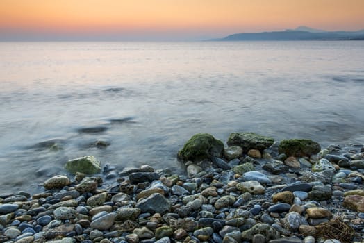 Sea waves lash line impact stone on the beach