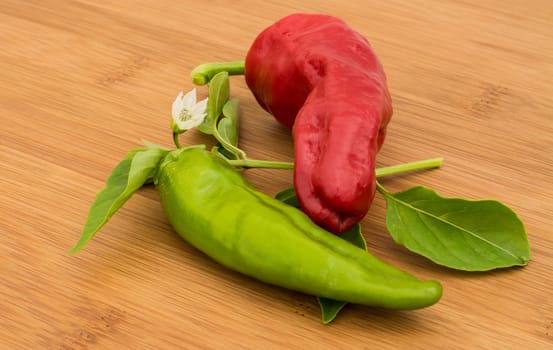 Chili Pepper, red and green on a bamboo chopping board 