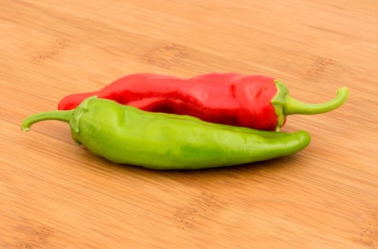 Chili Pepper, Red and Green on a bamboo chopping board