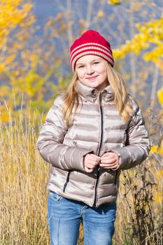Autumn photo of beautiful girl in red hat