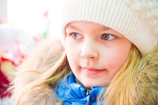 Photo of cute girl with blue eyes in white hat