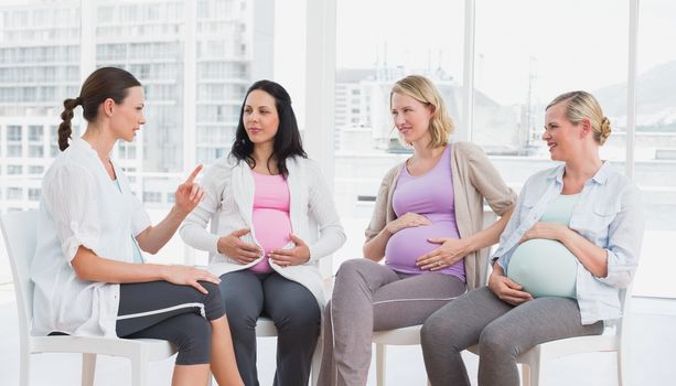 Pregnant women talking together at antenatal class at the hospital