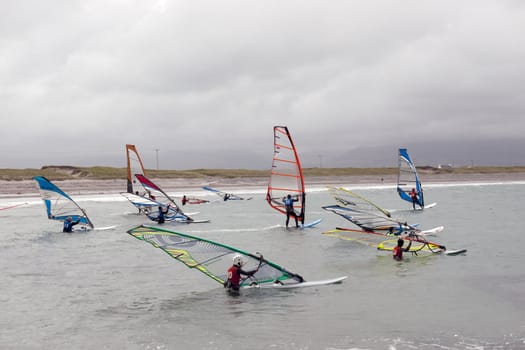 wind surfers racing in the storm winds on the wild atlantic way in county Kerry Ireland