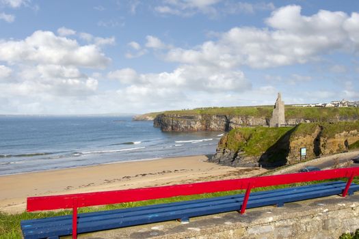 bench on a cliff edge with views of Ballybunion beach cliffs and castle